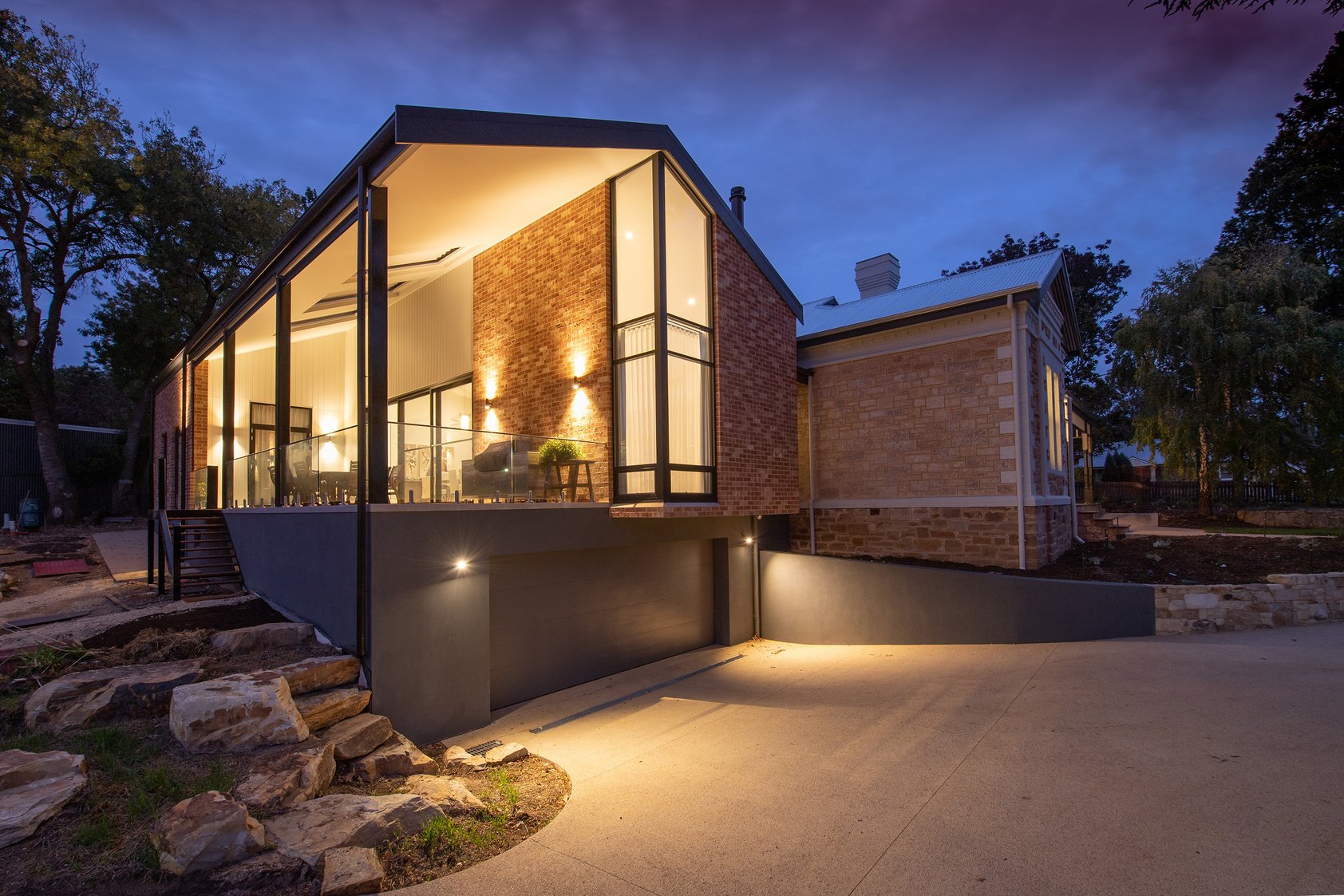 Modern house facade with glowing lights at dusk